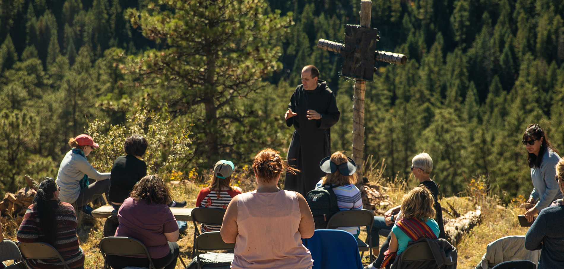 group gathered on beautiful mountain listening to Father Nathan