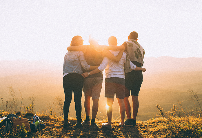 Hikers enjoying a sunrise over the mountains